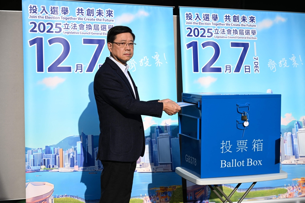 Hong Kong Chief Executive John Lee casts his vote in the Legislative Council elections in Hong Kong on December 7, 2025. — AFP pic