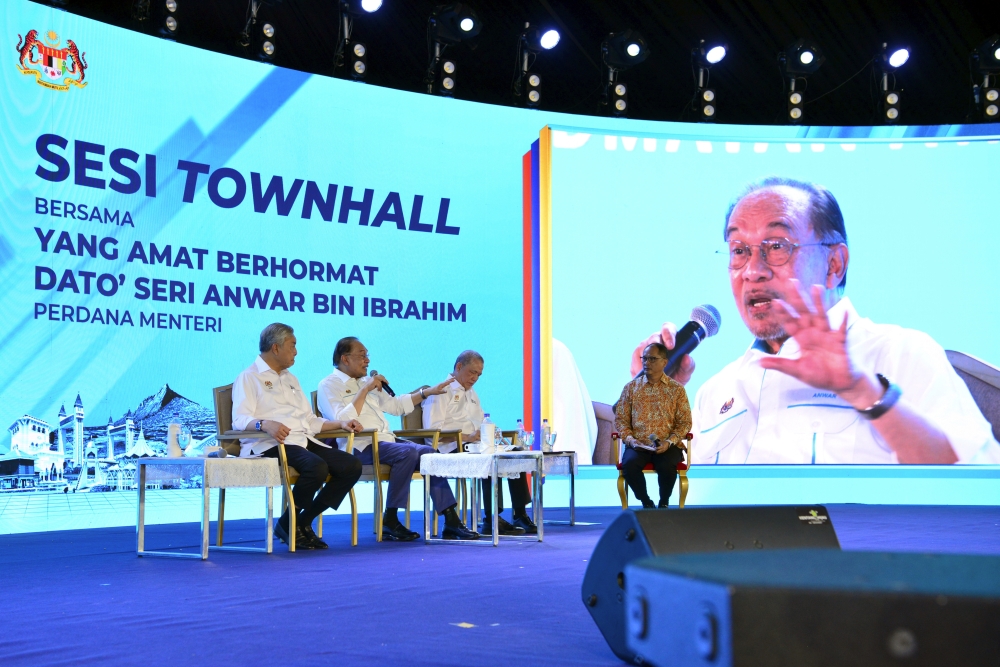 Prime Minister Datuk Seri Anwar Ibrahim speaks beside Deputy Prime Ministers Datuk Seri Ahmad Zahid Hamidi and Datuk Seri Fadillah Yusof in a townhall session during the ‘Rancakkan Madani’ programmer, Dataran Putrajaya December 7, 2025. — Bernama pic