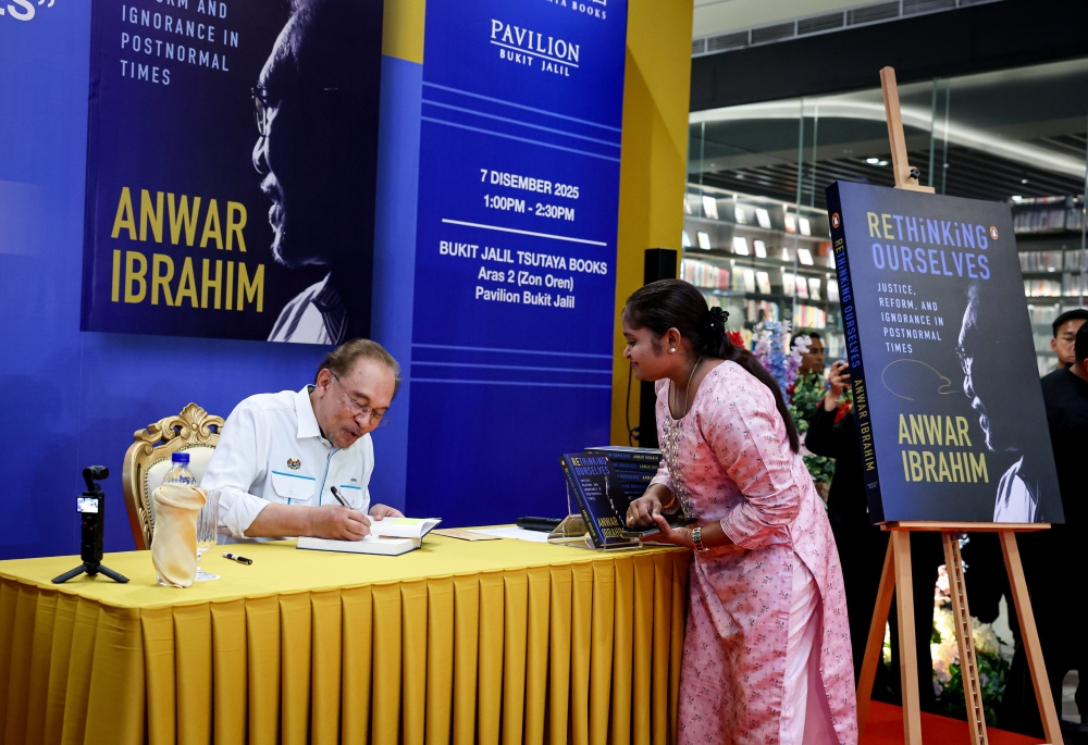 Prime Minister Datuk Seri Anwar Ibrahim signed copies of his latest book, ‘Rethinking Ourselves: Justice, Reform and Ignorance in Postnormal Times’ at its launch at Tsutaya Books, Pavilion Bukit Jalil, Kuala Lumpur on December 7, 2025. — Bernama pic