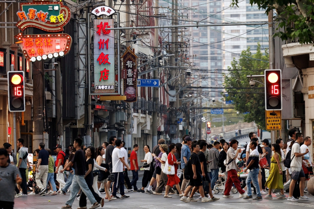 People walk past a lane lined up with restaurants, at a shopping area in Shanghai September 28, 2024. China approved a value-added tax law today to take effect on January 1, 2026, the official Xinhua said, bringing into one document previous regulations that have included exempting items from the tax. — Reuters pic