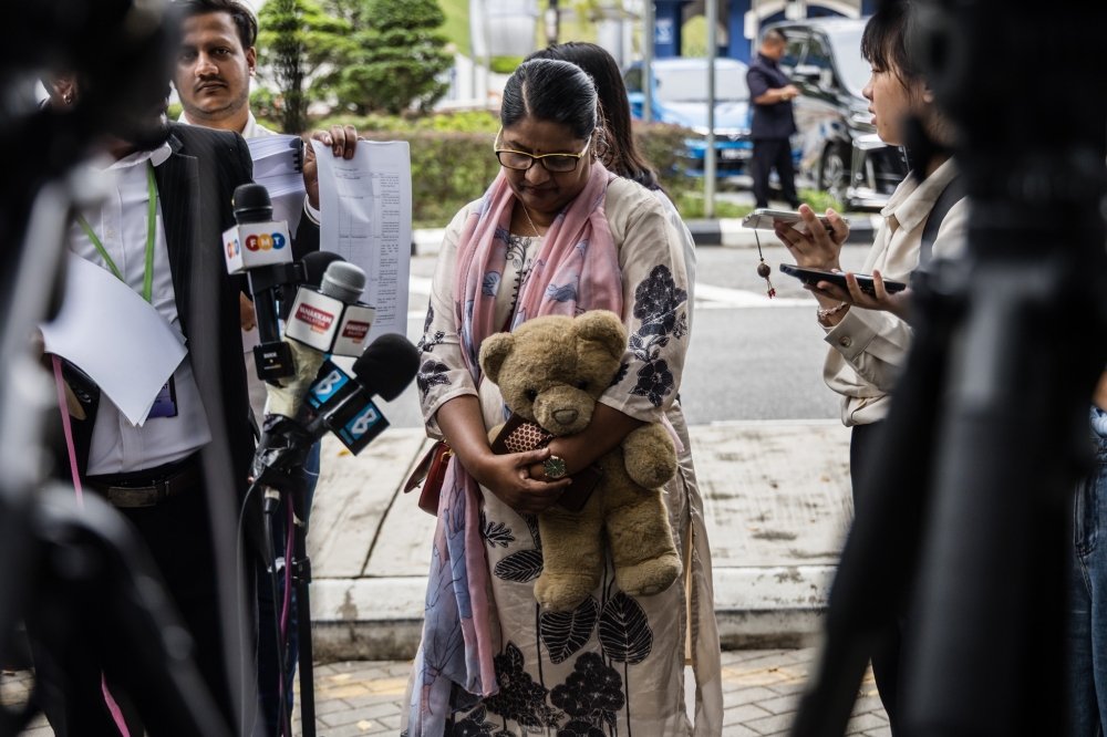 Indira Gandhi, holding her missing daughter’s teddy bear, is seen before the meeting with IGP Tan Sri Mohd Khalid Ismail at the Bukit Aman police headquarters in Kuala Lumpur December 10, 2025. — Picture by Firdaus Latif