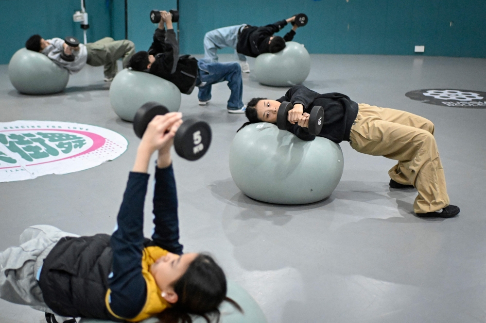 This picture taken on November 26, 2025 shows Guo Pu (right) training with her teammates at a breakdancing studio in Pingyi county, in eastern China's Shandong province. — AFP pic
