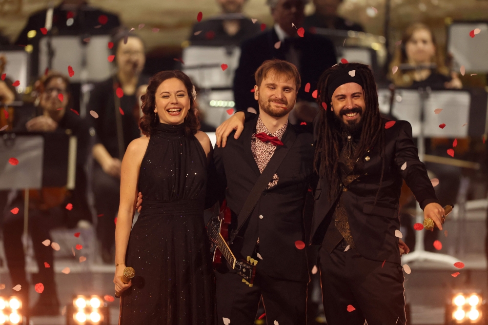 French singer Alice Duport-Percier (left) poses with Lorien Testard (centre), composer of the soundtrack of the video game ‘Clair Obscur: Expedition 33’, after performing during The Game Awards at the Peacock Theatre in Los Angeles December 11, 2025. — AFP pic