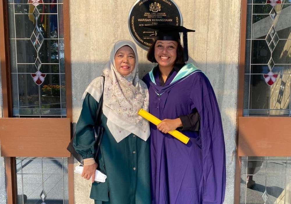 The author, Zuraini Md Ali (left), with her student at the University of Malaya graduation ceremony. — Picture courtesy of Zuraini Md Ali