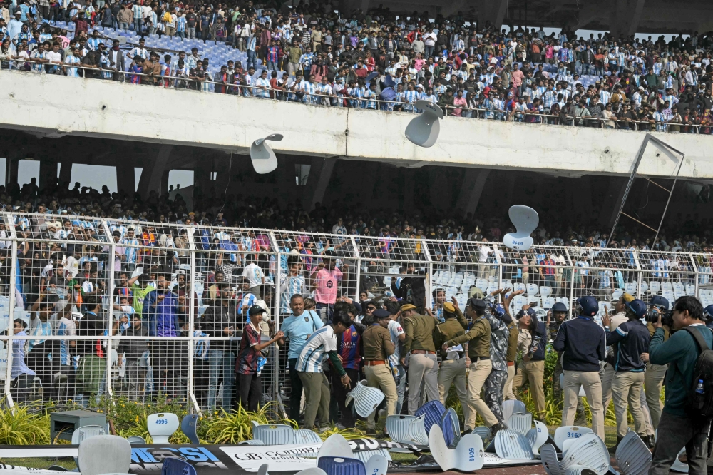 Fans hurl chairs as Inter Miami and Argentina star Lionel Messi leaves Salt Lake Stadium in Kolkata, India on December 13, 2025. — AFP pic