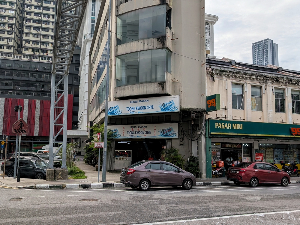 Look for the tall corner building with white shop signs. — Picture by Ethan Lau
