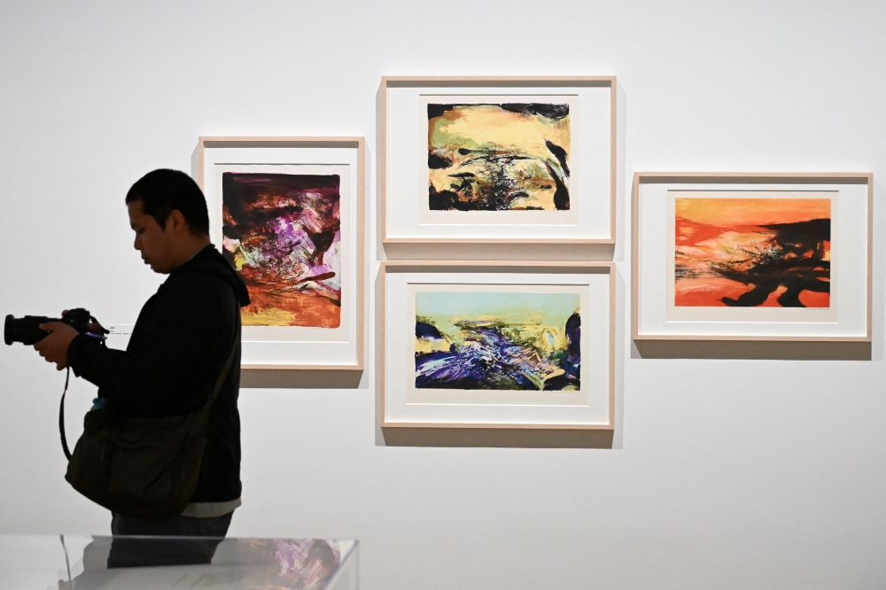 A photographer takes photos at a media preview of M  art museums special exhibition titled 