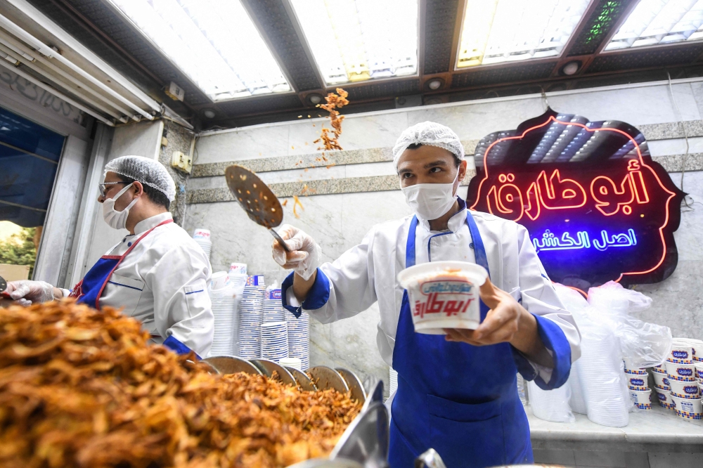 An Egyptian chef prepares a traditional dish in Arabic known as Koshary at Abou Tarek restaurant downtown Cairo on December 10, 2025. — AFP pic