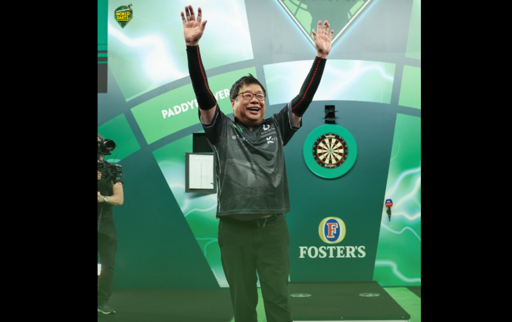 Singapore stalwart Paul Lim became the oldest player to win a match at the World Darts Championship when the 71-year-old beat Jeffrey de Graaf 3-1 at Alexandra Palace in London on Saturday. — Picture via Facebook/PDC Europe