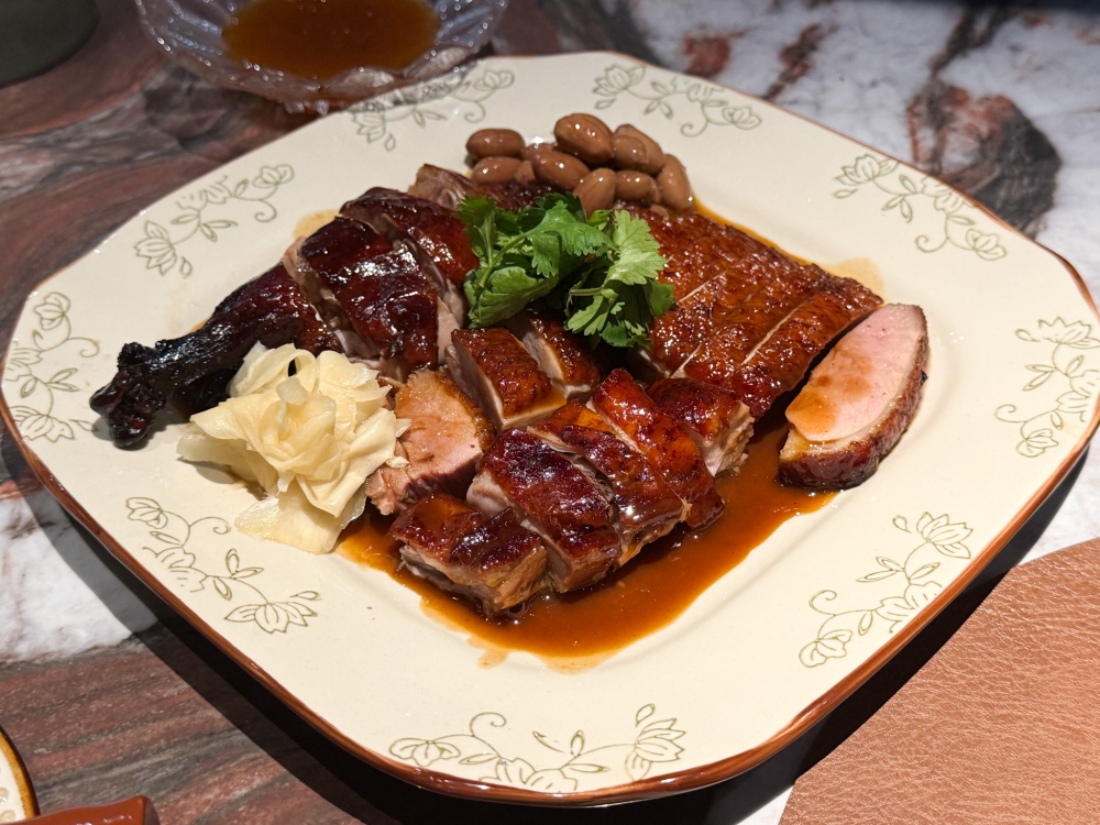 Relish the juicy THB Signature Roast Duck with pickles and braised peanuts. — Picture by Lee Khang Yi