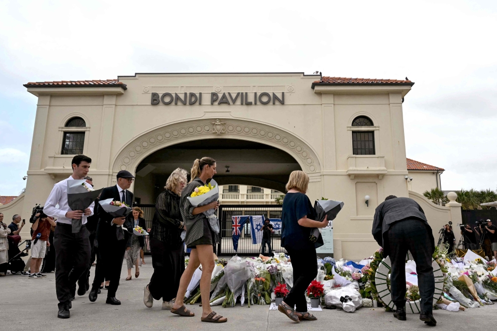 Mourners pay a floral tribute to Bondi Beach shooting victims at the Bondi Pavilion in Sydney on December 15, 2025. — AFP pic