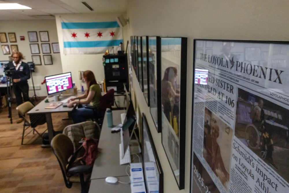 Press cutouts hang on a wall as Lilli Malone, a student at Loyola University and editor in chief of The Loyola Phoenix newspaper, looks at a screen during the closing night at the university newsroom in downtown Chicago, Illinois November 11, 2025. — Reuters pic