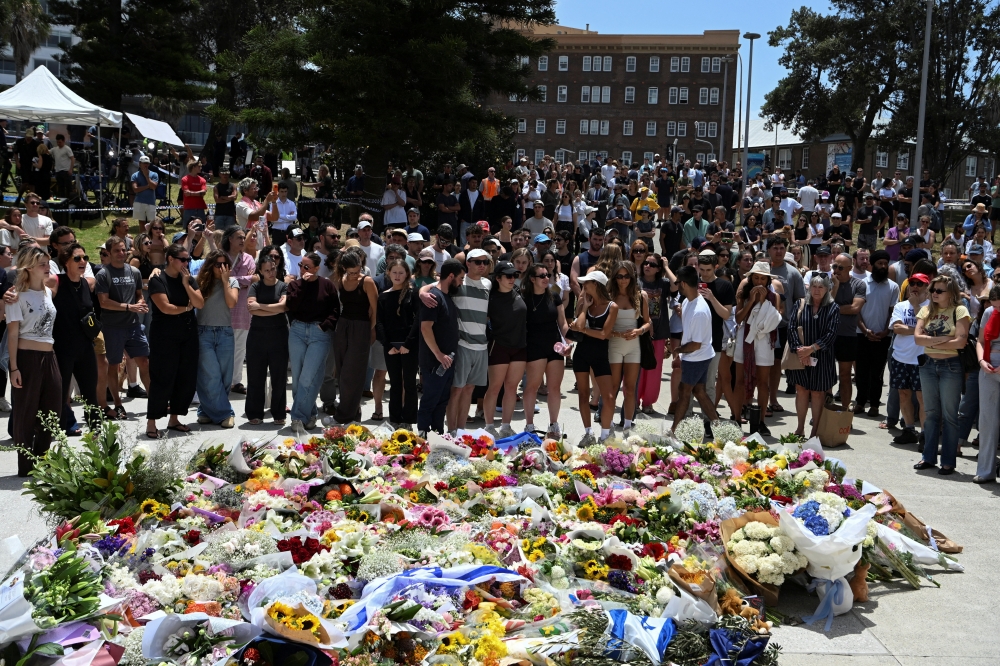 People react in front of a flower tribute near Bondi Pavilion following a shooting incident at Bondi Beach in Sydney December 15, 2025. — Reuters pic  