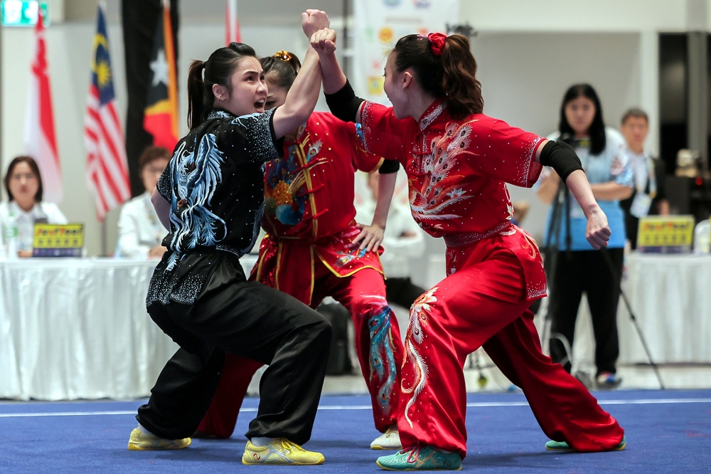 Malaysia’s Sydney Chin Sy Xuan, Lo Yin Ting and Mandy Cebelle Chen compete in the women’s bare‑handed duilian event at the 33rd SEA Games in Bangkok, Thailand December 13, 2025. — Bernama pic