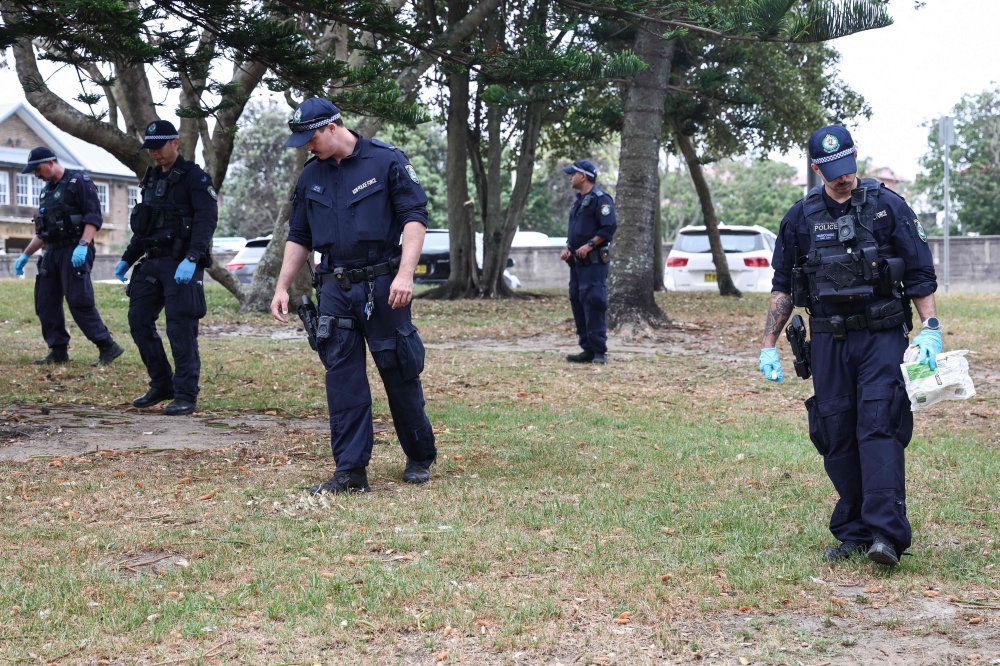 The police search for evidence around the area where the Bondi Beach shooting took place in Sydney on December 16, 2025. — AFP pic 
