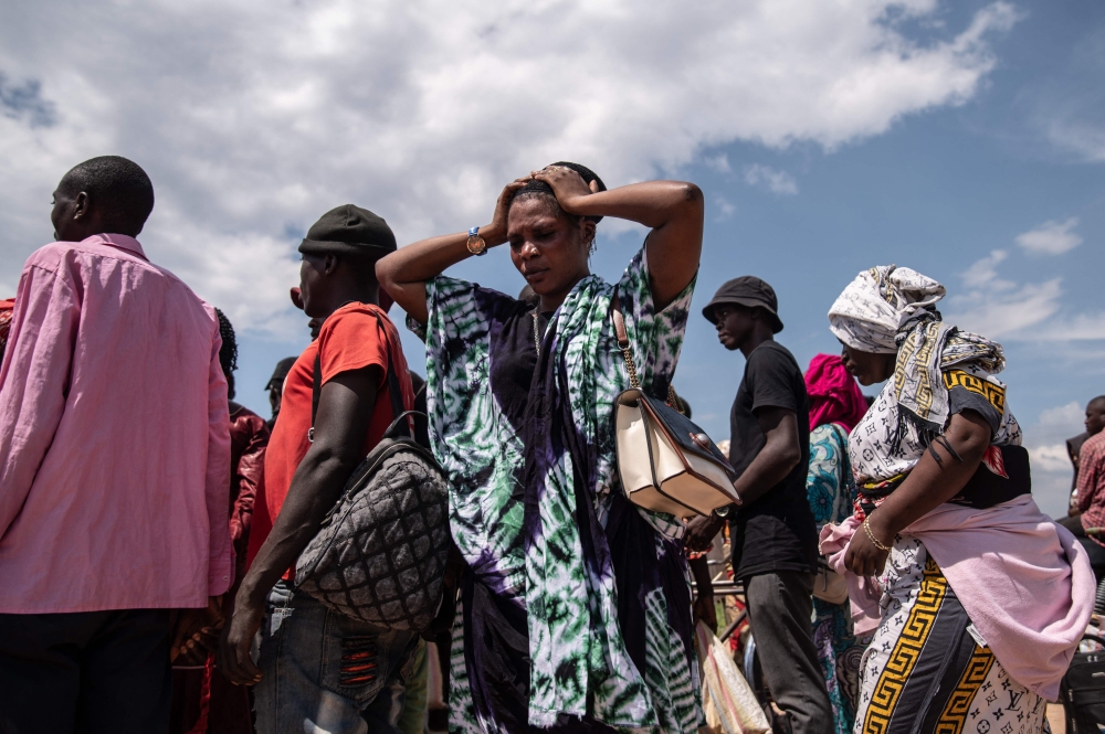 A displaced Burundian woman reacts as she remains stranded with others on the Congolese side following the closure of the border between the Democratic Republic of Congo and Burundi at the Kavimvira border post on December 14, 2025. — AFP pic