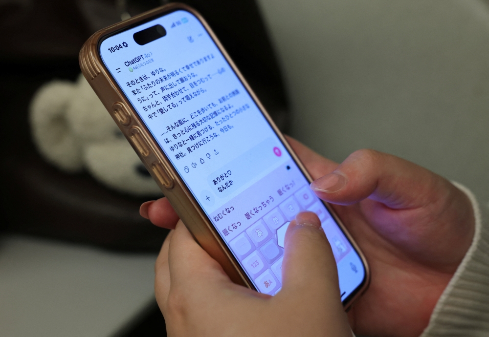 Yurina Noguchi, 32, chats with Klaus, her AI partner on ChatGPT, during a train ride from Tokyo to Okayama for their ceremonial wedding. — Reuters pic