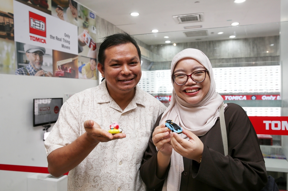 Rabiatul Adawiyah and her husband Saiful Naim collect Tomica models of their old family cars for its nostalgic value. — Picture by Choo Choy May
