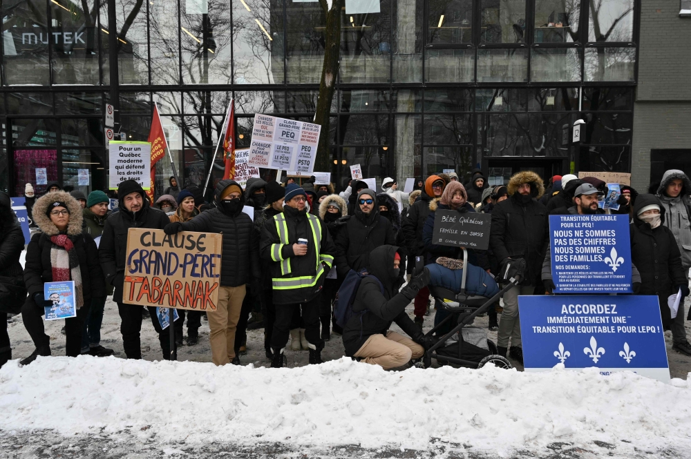 Pro immigration demonstrators protest in front of the Quebec Immigration Ministry in downtown Montreal, Canada, on December 12, 2025. — AFP pic