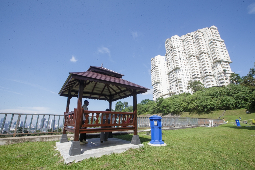 Visitors sit at a gazebo overlooking Kuala Lumpur at Panorama Bukit Antarabangsa in Hulu Kelang, Ampang Jaya today. — Picture by Raymond Manuel