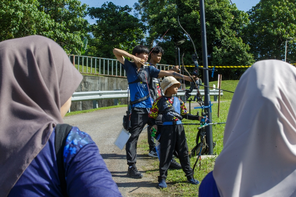 Participants compete at the National Field Archery Championship at Panorama Bukit Antarabangsa in Hulu Kelang, Ampang Jaya today. — 