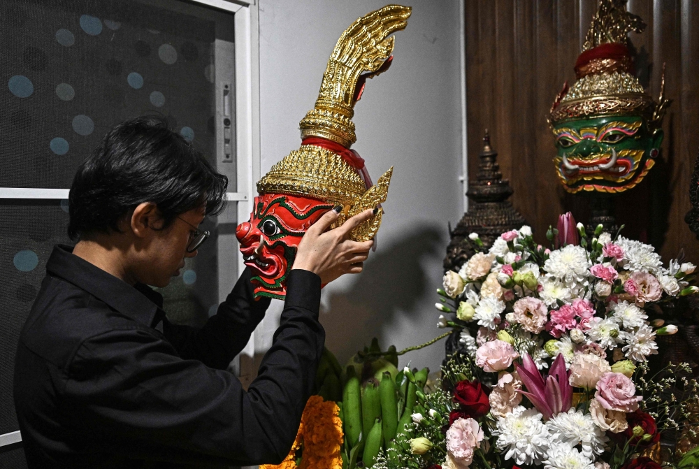 This photo taken on December 7, 2025 shows astrologer Linn Nhyo Taryar from Myanmar praying to a shrine at his home in Bangkok. — AFP pic 