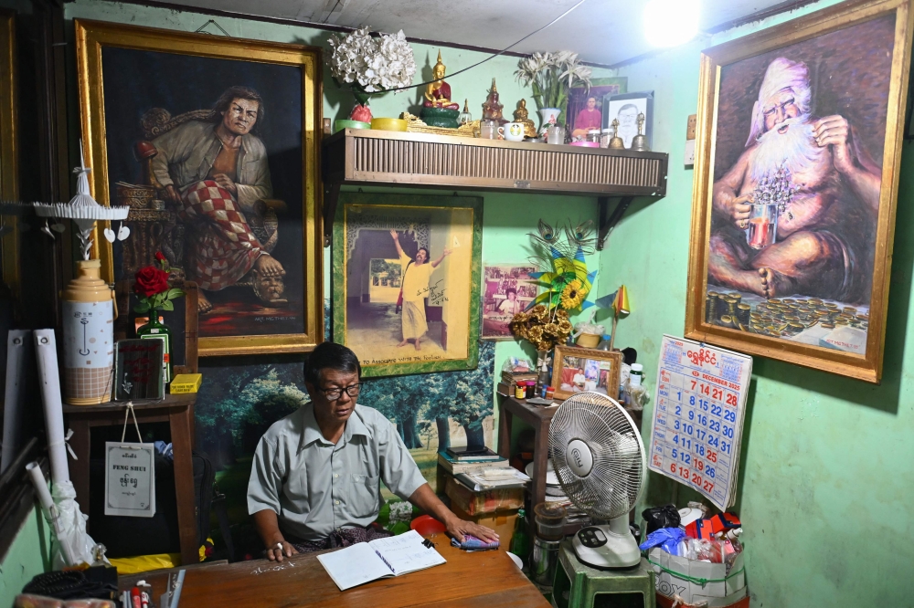 This photo taken on December 17, 2025 show astrologer Min Thein Kyaw at his fortune-telling studio in Yangon. — AFP pic 