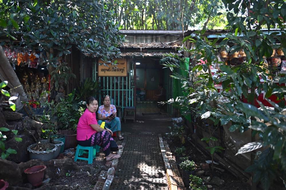 This photo taken on December 17, 2025 show people waiting outside the studio of astrologer Min Thein Kyaw in Yangon. — AFP pic 