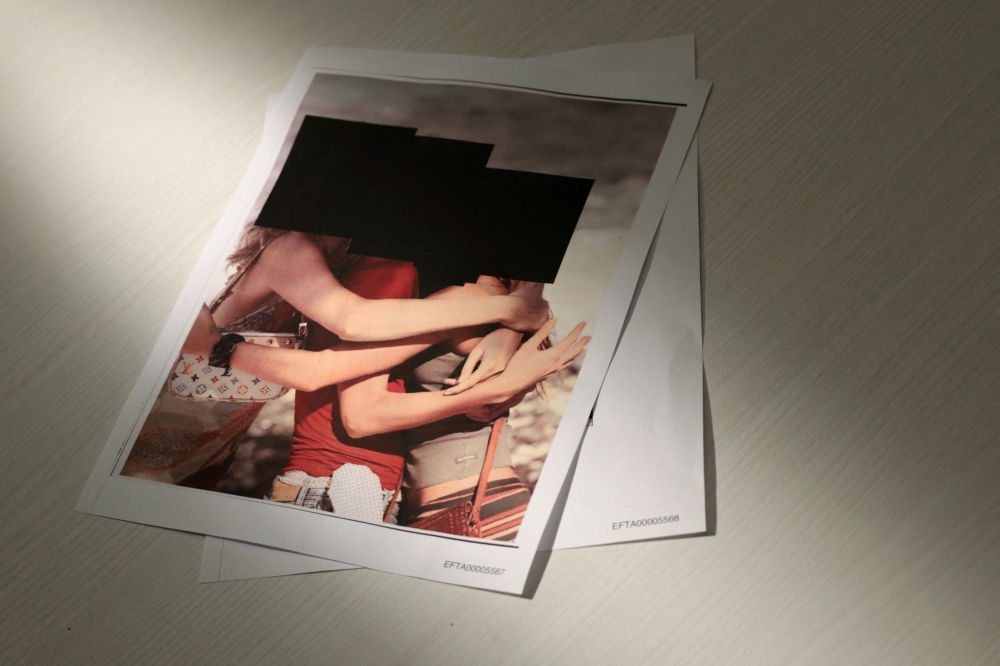 Handout images from the US Justice Department show newly released documents from the late financier and sex offender Jeffrey Epstein, including redacted photos of women, in Washington, D.C. on December 19, 2025. — Reuters pic