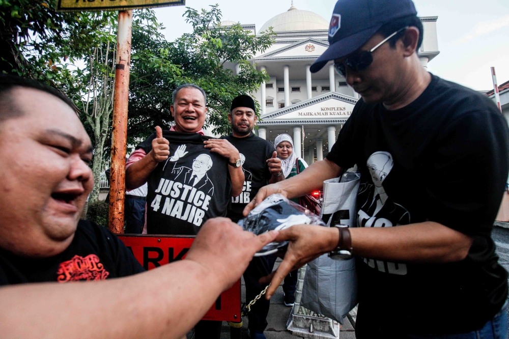 According to ‘Harian Metro’, supporters began assembling as early as 7am, with crowds swelling around the court compound amid chants of ‘Justice for Najib’ and ‘Lawan tetap lawan’. — Picture by Sayuti Zainudin