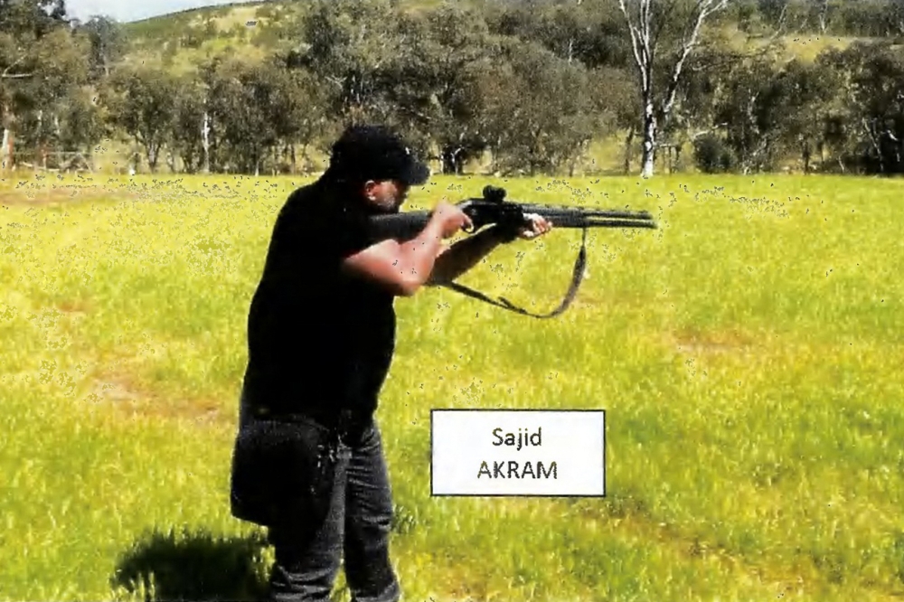 A video frame grab released by the New South Wales Courts on December 22, 2025 shows Sajid Akram firing a shotgun and moving in a tactical manner in a countryside location in October 2025. — AFP pic