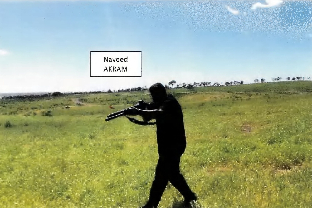A video frame grab released by the New South Wales Courts on December 22, 2025 shows Naveed Akram allegedly firing a shotgun and moving in a tactical manner in a countryside location in October 2025. — AFP pic