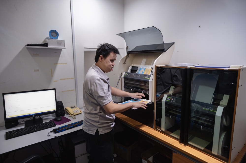 YOBM Publishing Officer and Information Technology Trainer Andy Boo Teck Joo said each dictionary set is produced through a combination of manual and digital processes. — Bernama pic