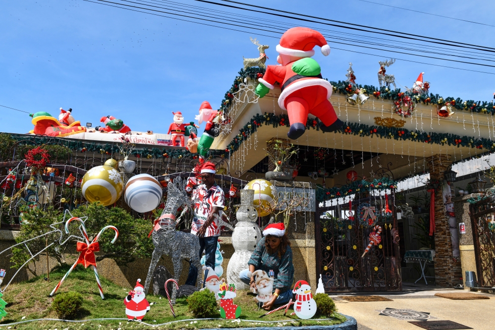 D. Charles, 53 (left), and his wife S. Christe, 48, decorate their home with Christmas decorations at Taman Teluk Molek, Teluk Air Tawar. — Bernama pic