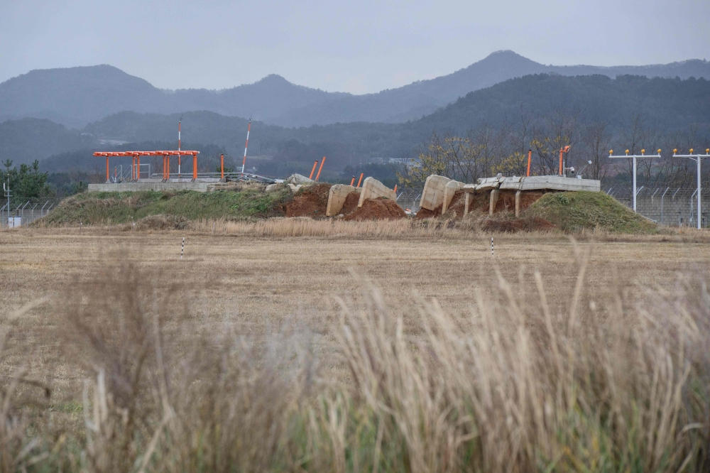 In this photo taken on December 14, 2025, a damaged structure is seen at the end of the runway at Muan International Airport, where Jeju Air's Flight 2216 crashed after making a belly landing on December 29, 2024. — AFP pic