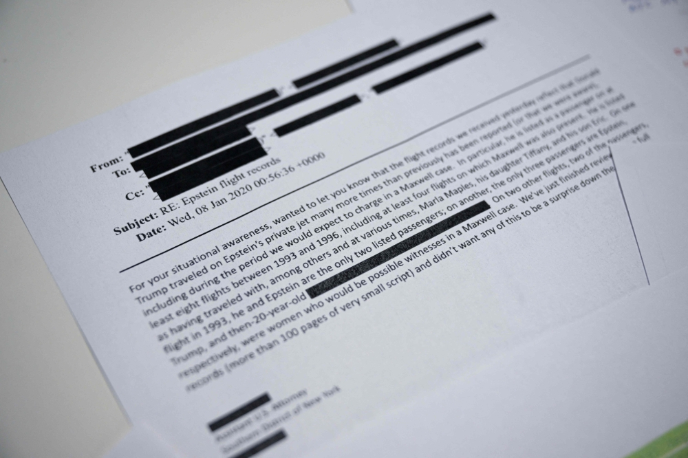 This photo illustration taken in Washington, DC, on December 23, 2025 shows part of a new batch of files released on Tuesday by the US government in relation to the notorious late sex offender Jeffrey Epstein containing numerous references to Donald Trump, including documents detailing flights he took on his then close friend's private jet. — US Justice Department handout/AFP pic