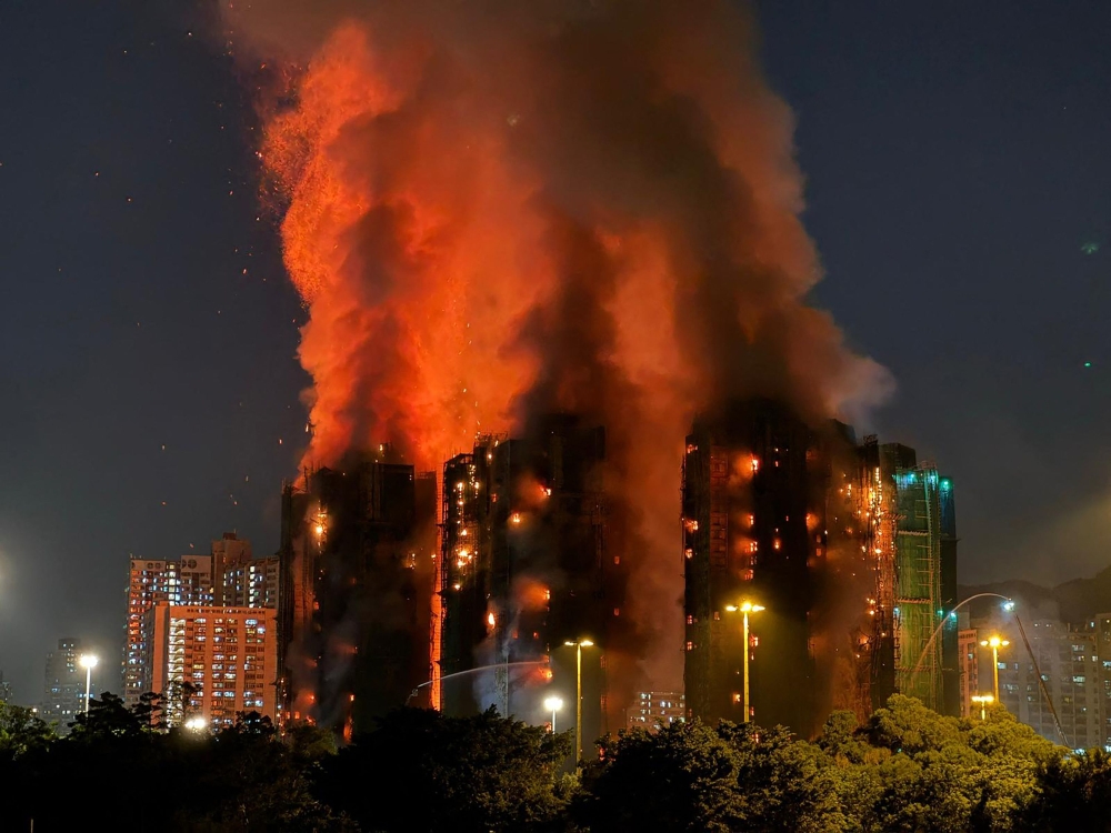 Thick smoke and flames rise as a major fire engulfs several apartment blocks at the Wang Fuk Court residential estate in Hong Kong’s Tai Po district November 26, 2025. — AFP pic