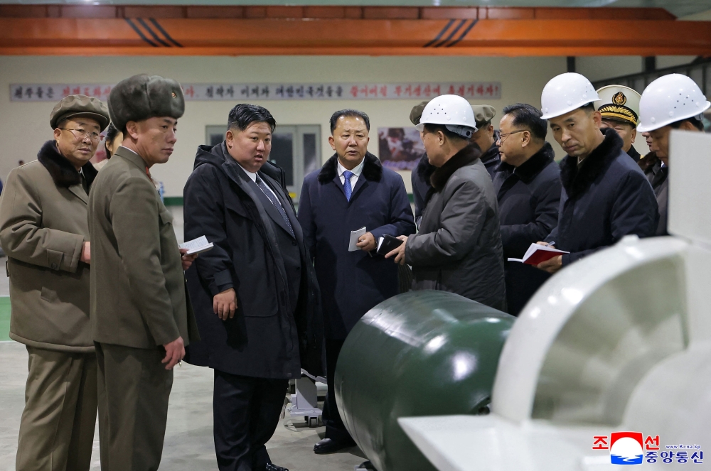This undated picture released by North Korea's official Korean Central News Agency (KCNA) via KNS on December 25, 2025 shows North Korean leader Kim Jong Un visits the manufacturing site of an 8,700-tonnage nuclear-powered strategic guided missile submarine at an undisclosed location in North Korea. — KCNA pic via KNS/AFP 