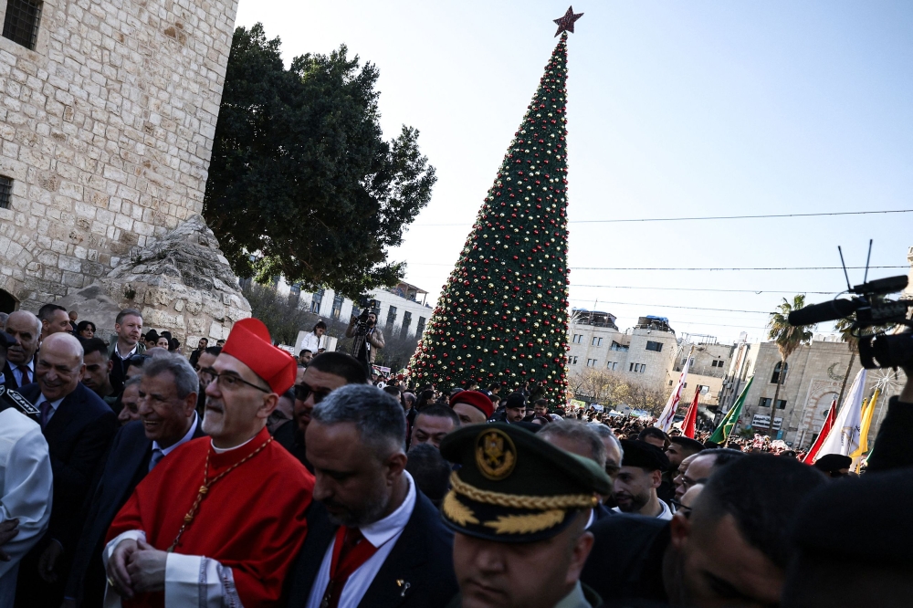Latin Patriarch of Jerusalem Italian Pierbattista Pizzaballa is welcomed by pilgrims, tourists and Palestinians as he arrive to lead the Christmas Mass in the Church of the Nativity in the Israeli-occupied West Bank city of Bethlehem, believed to be the birthplace of Jesus Christ, on December 24, 2025. — AFP pic