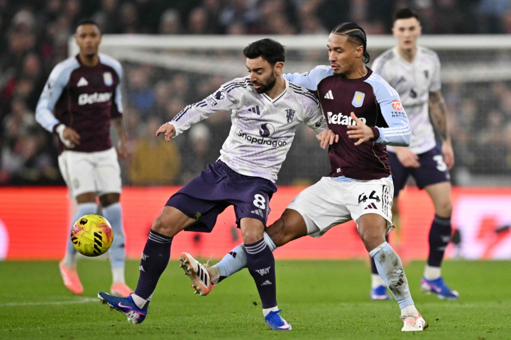 Aston Villa's French midfielder #44 Boubacar Kamara (right) fouls Manchester United's Portuguese midfielder #08 Bruno Fernandes (left) during the English Premier League football match between Aston Villa and Manchester United at Villa Park in Birmingham December 21, 2025. — AFP pic 