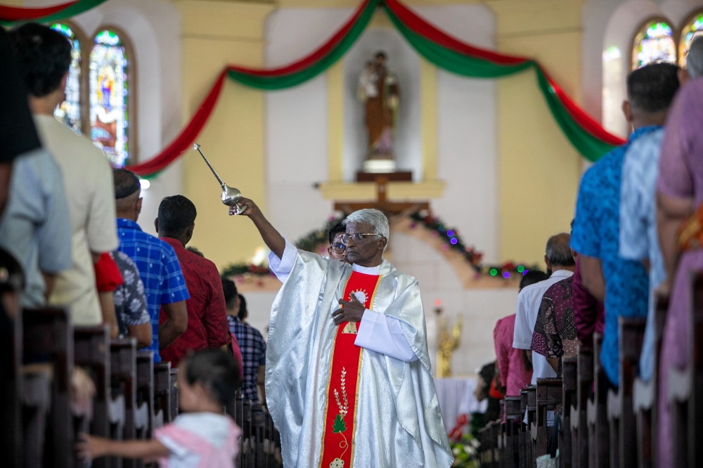 Church of St Joseph priest Francis Andrew conducts a religious ceremony in conjunction with Christmas celebrations in Batu Gajah. — Bernama pic 