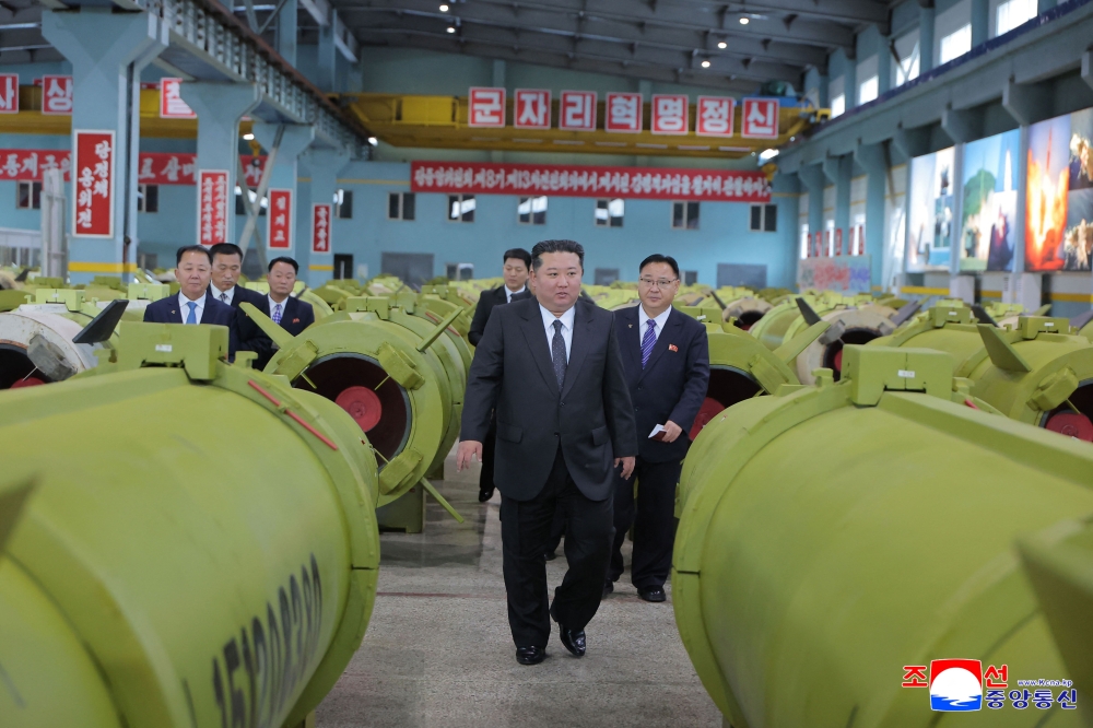 This undated picture released by North Korea's official Korean Central News Agency (KCNA) on December 26, 2025 shows North Korean leader Kim Jong Un (centre) visiting major munitions industry enterprises to acquaint himself with the missile and shell production at an undisclosed place in North Korea. — KCNA pic via KNS/AFP