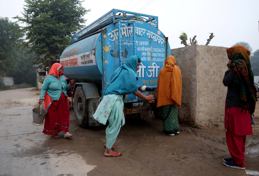 Women collect water from a tanker in a village in Alwar, Rajasthan, November 20, 2025. — Reuters pic
