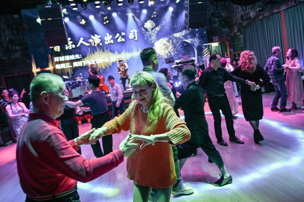 Guests dance at the Shiguang Dance Hall in the Putuo district of Shanghai December 10, 2025. — AFP pic