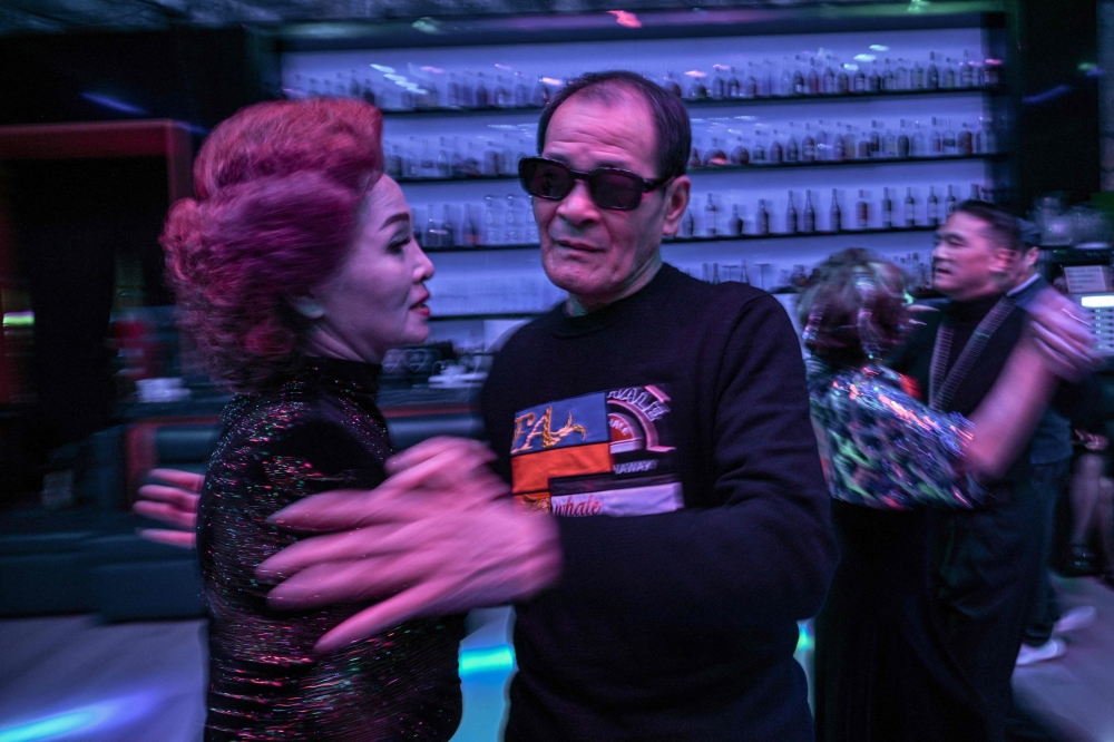 Guests dance at the Shiguang Dance Hall in the Putuo district of Shanghai December 10, 2025. — AFP pic