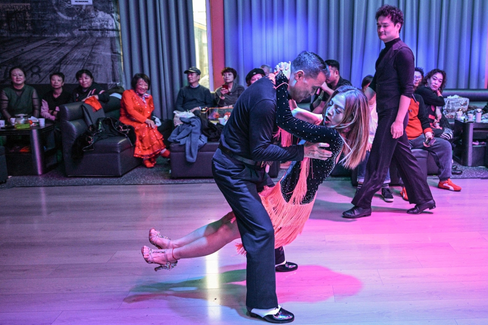 Xu Li dances with a partner at the Shiguang Dance Hall in the Putuo district of Shanghai December 10, 2025. — AFP pic