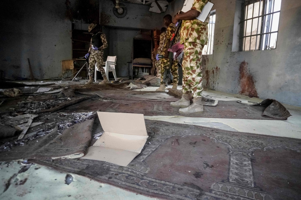 Military officers inspect a mosque in Maiduguri, capital of Borno state in northeastern Nigeria, and base of Boko Haram, an Islamic State West Africa offshoot, after a blast on December 24, 2025, killed at least seven worshippers. — AFP pic