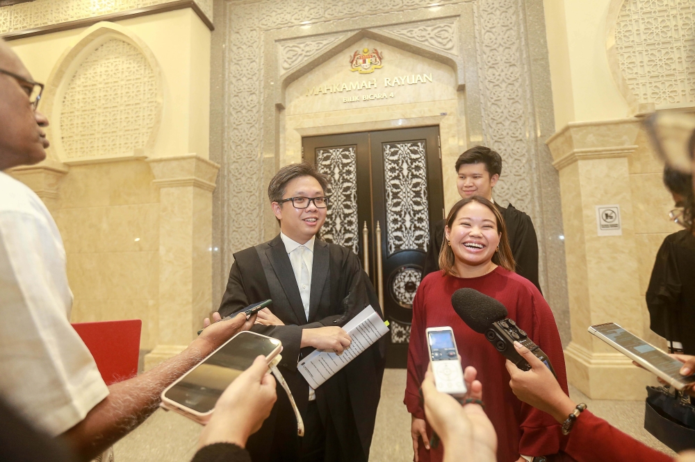 Lawyer New Sin Yew (left) along with his client, activist Heidy Quah speaks to the press after the Court of Appeal's decision on her constitutional challenge against parts of Section 233 of the Communications and Multimedia Act here at the Palace of Justice, Putrajaya. — Picture by Sayuti Zainudin