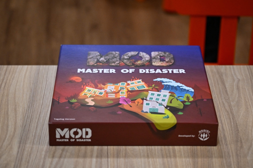 This photo taken on December 9, 2025, shows the Master of Disaster, a board game about disaster preparedness, at a library in Valenzuela, Metro Manila. In a library in the Philippines, a die rattles on the surface of a board before coming to a stop, putting one of its players directly in the path of a powerful typhoon. — AFP pic