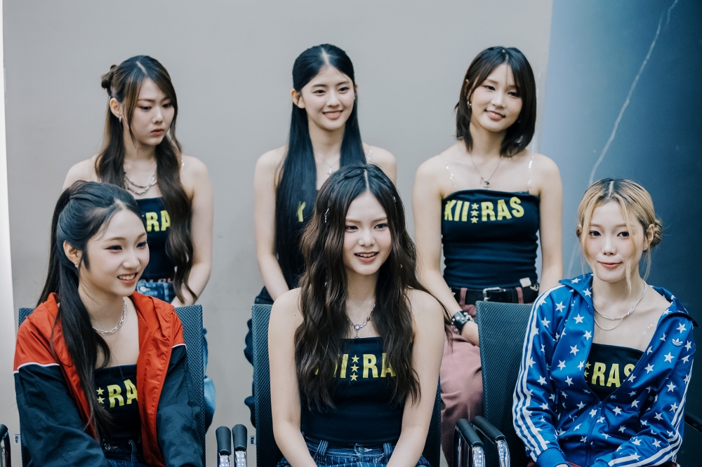Alicia Wong Lingling (sitting down in the middle) is the first Malaysia female K-pop idol who is leading her KIIRAS group. — Picture by Firdaus Latif